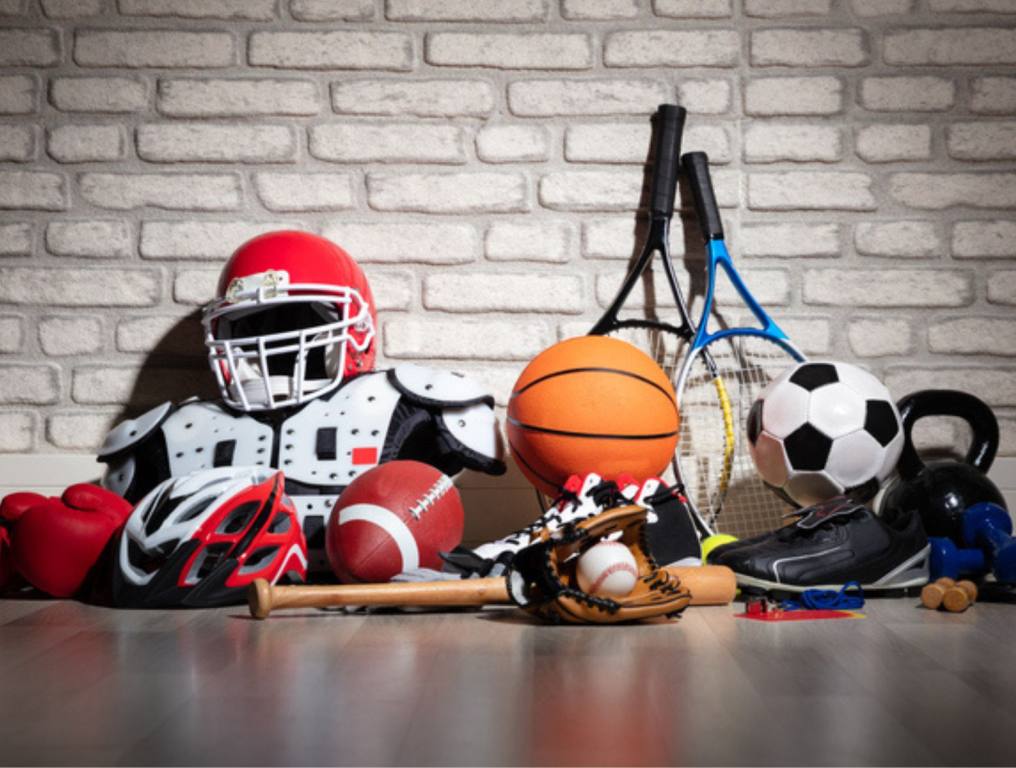 Various Sport Equipment On Floor In Front Of Brick Wall (Study Reveals the Most Popular Sport Across the Nation)