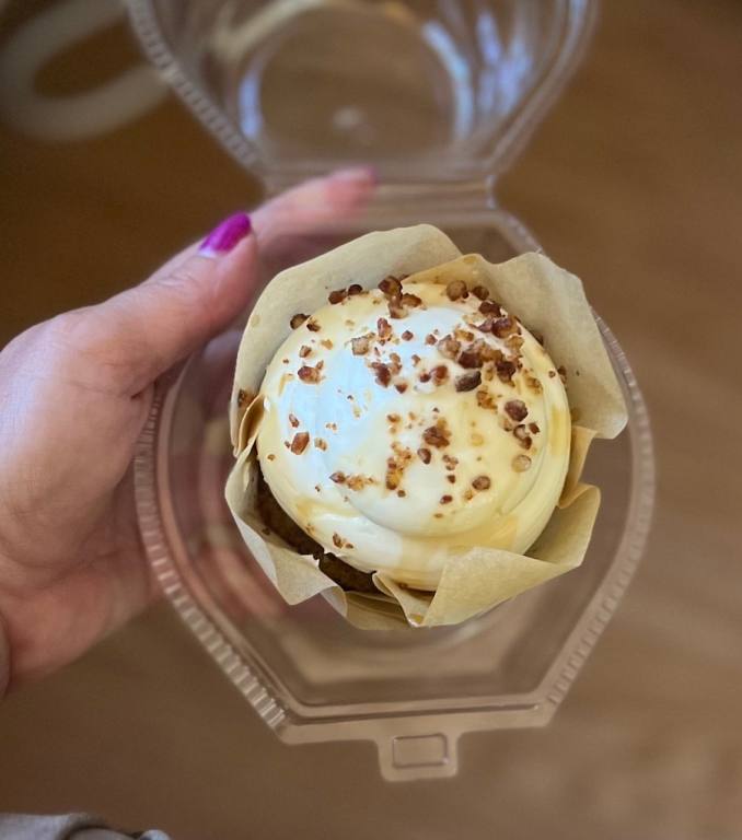 Ladies hand holding a Carrot Cake Cupcake