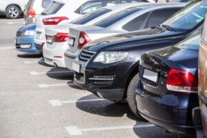 line of cars in a parking lot from the back