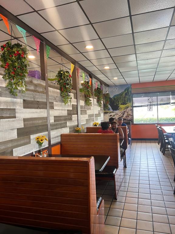 Inside the restaurant, booths line one side of the wall, it is clean and bright.