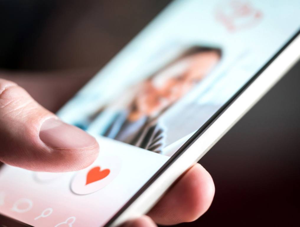 Dating app or site in mobile phone screen. Man swiping and liking profiles on relationship site or application. Single guy using smartphone to find love, partner and girlfriend. Mockup website.