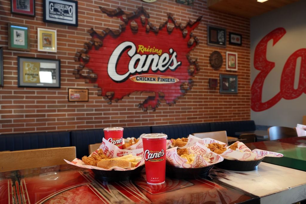 Displays and signage are seen during LA Dodgers' Mookie Betts Makes "Shortstop" at Raising Cane's Ahead of Opening Day. Popular Fast Food