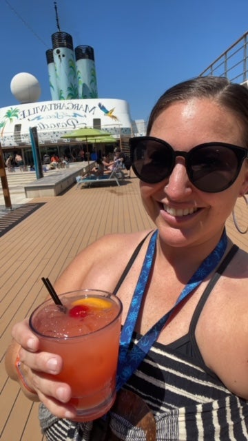 marija with drink on pool deck