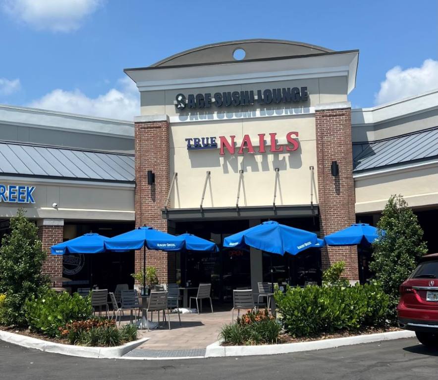 Outside view of Sage Sushi Lounge in the corner of a strip mall