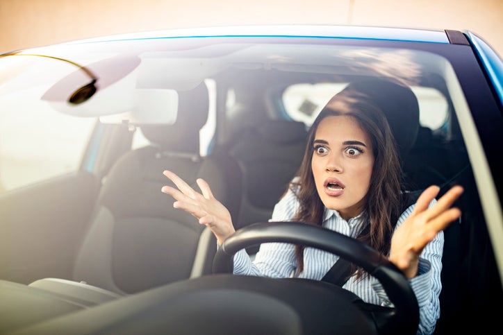 Woman is driving her car very aggressive and gives gesture with her fist. Angry female driver. Negative human emotions face expression. Furious woman stucked in traffic jam. hard to image some stat4es have even worse drivers than Florida.