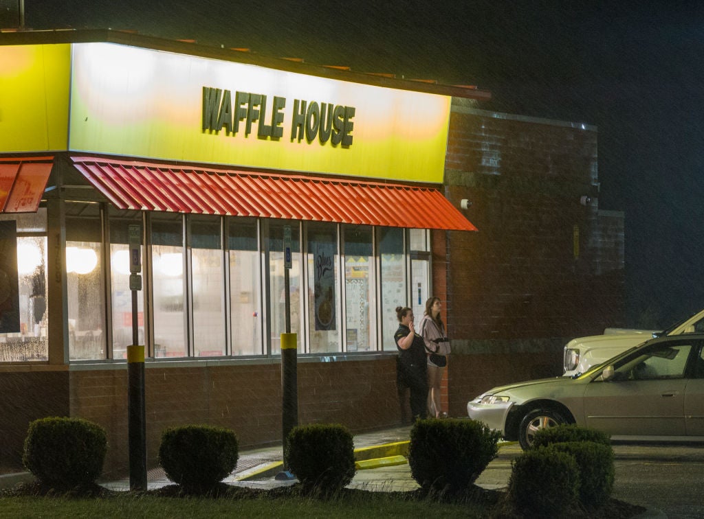 Woman standing outside smoking after a Waffle House Brawl