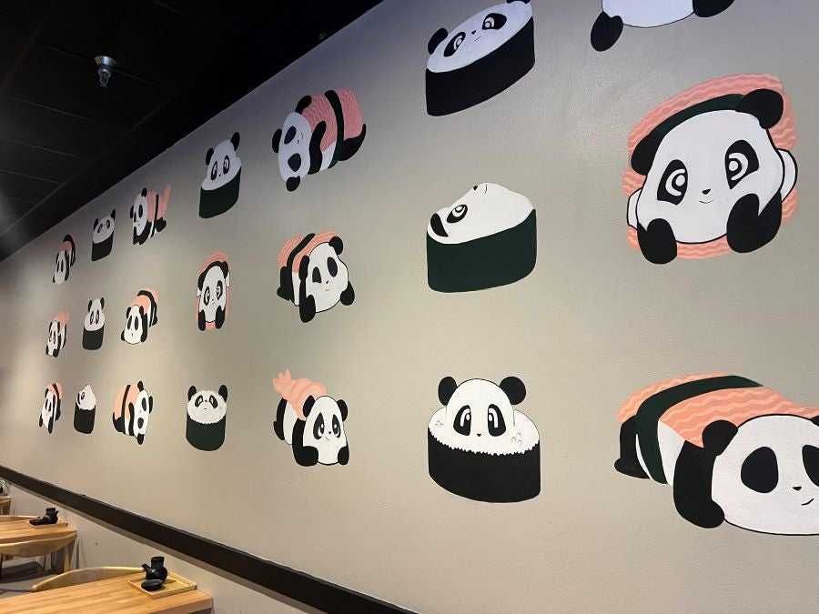 Restaurant wall with paintings of panda bears shaped like pieces of a sushi roll