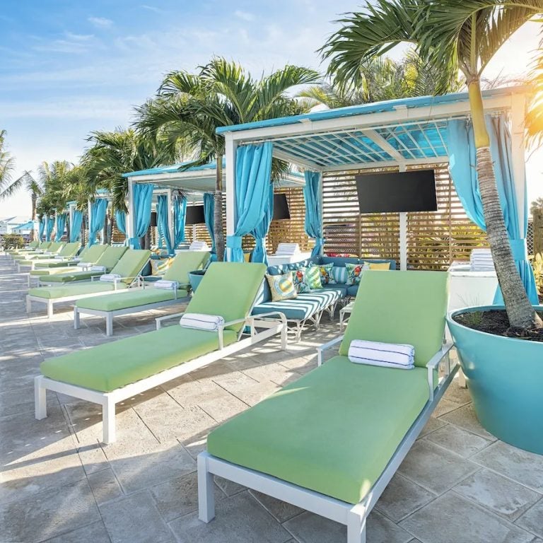 Green lounge chairs and blue beach cabanas for Jimmy Buffett Day In Fort Myers And Naples