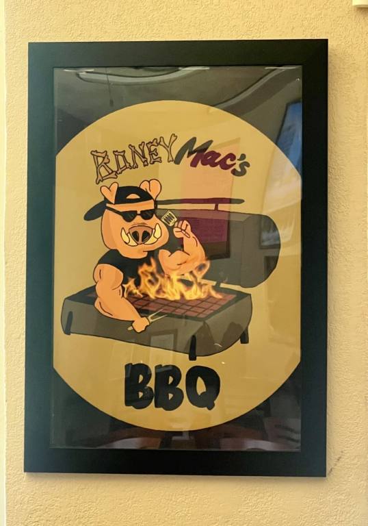 Poster of cartoon pig inside of a flaming BBQ grill