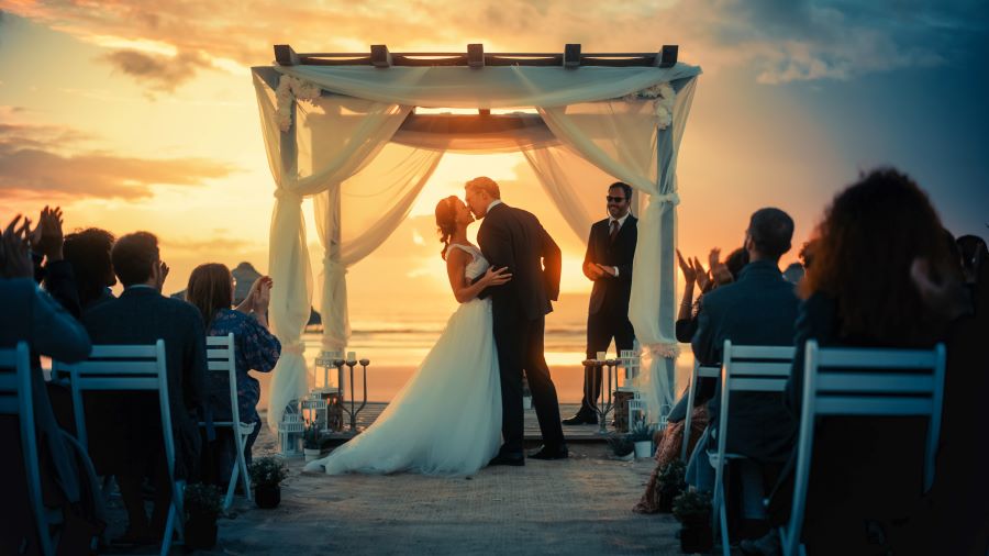 Bride and Groom kissing at sunset on the beach