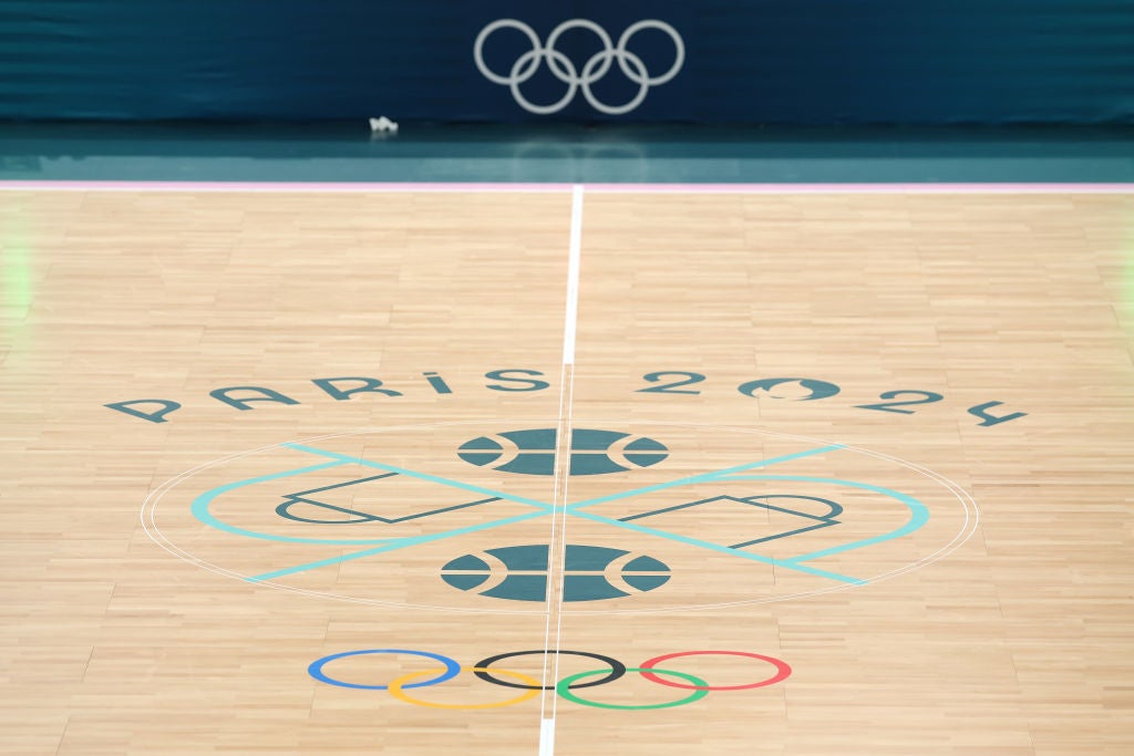 the Olympic Logo on the floor of a basketball court