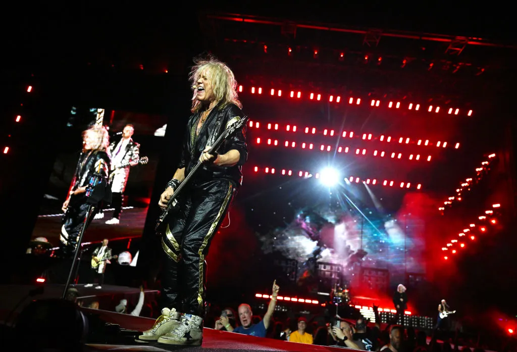 Rick Savage of Def Leppard performs onstage during the "Summer Stadium" tour at Truist Park on July 13, 2024 in Atlanta, Georgia.