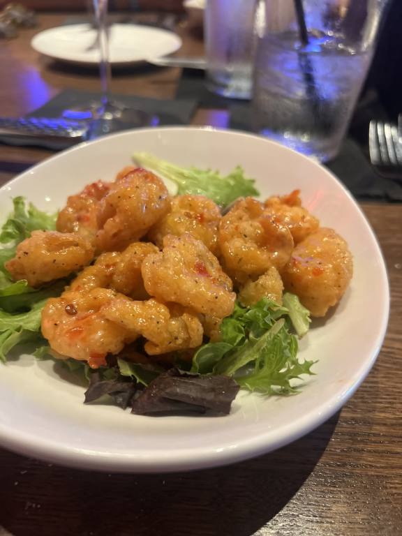 plate of fried shrimp on greens