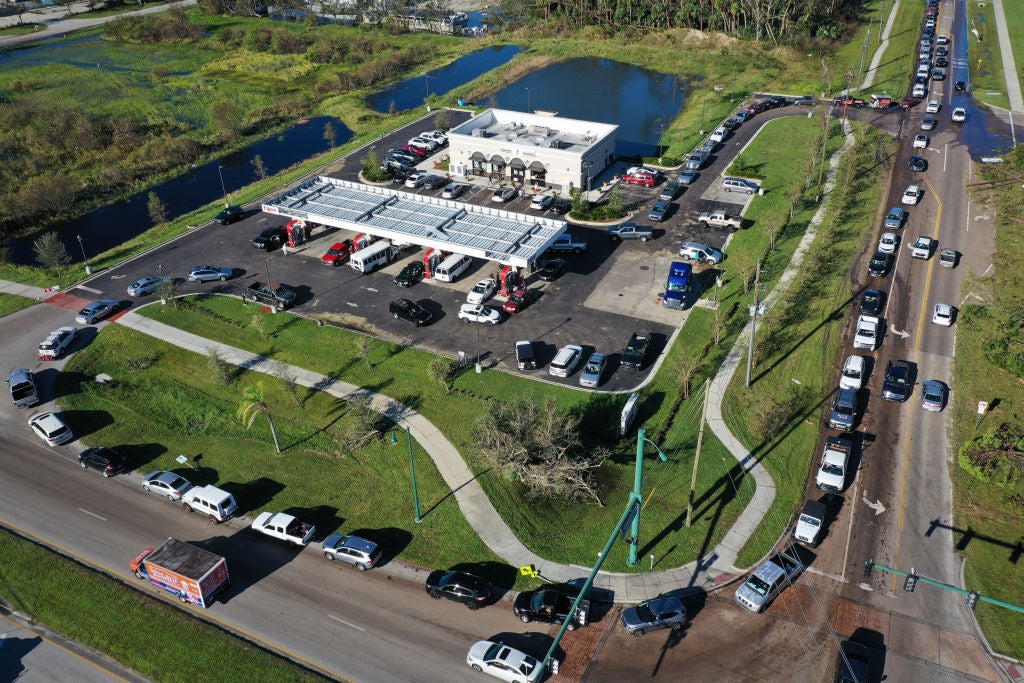 In this aerial view, vehicles line up to purchase gasoline from a fuel depot in Port Charlotte, Florida. (Photo by Win McNamee/Getty Images)