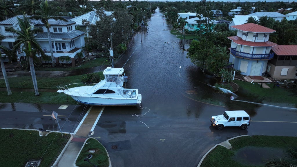 In this aerial view, a boat rests in a street after it was washed ashore when Hurricane Milton passed through the area on October 10, 2024, in Punta Gorda, Florida. The storm made landfall as a Category 3 hurricane in the Siesta Key area of Florida, causing damage and flooding throughout Central Florida.