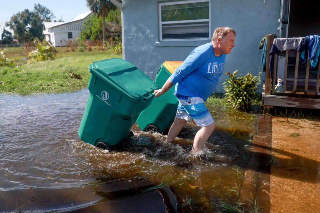 Here's the distribution points for Charlotte County. Shawn Hall retrieves his trash cans after they floated away when his home was inundated with water when Hurricane Milton passed through the area on October 10, 2024, in Punta Gorda, Florida. The storm made landfall as a Category 3 hurricane in the Siesta Key area of Florida, causing damage and flooding throughout Central Florida.