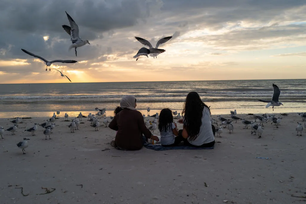 People visit the nearly empty beach as the community starts to recover from Hurricane Milton in Clearwater Beach, Florida.