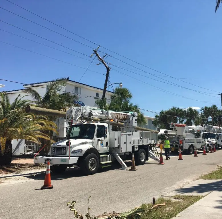 Storm restoration crews Storm restoration crews FPL trucks on residential street