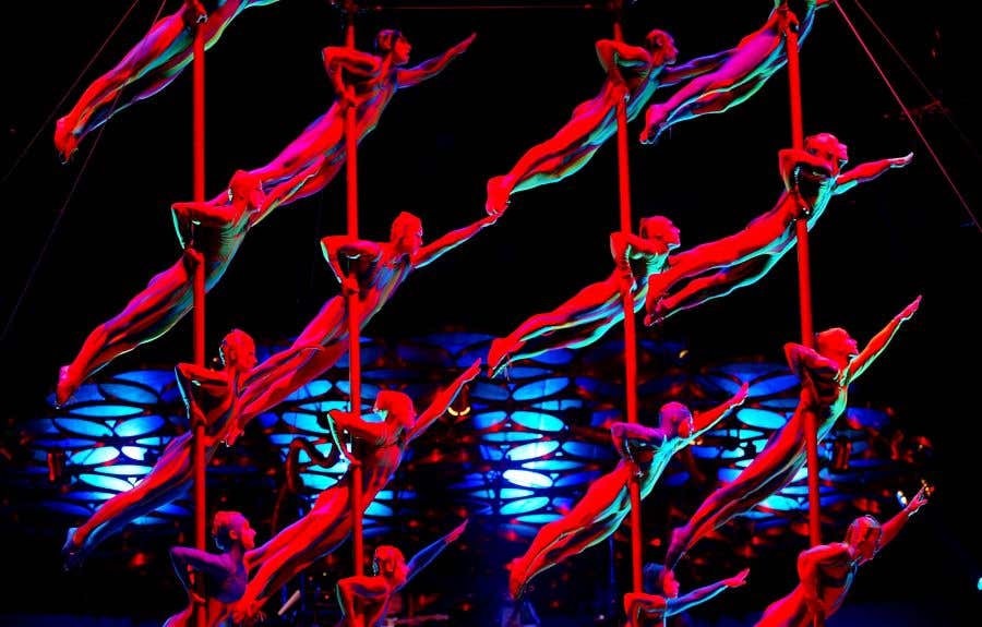 silhouettes of people in red body suits, suspending themselves on poles with one arm, bodies at 35 degree angles for weekend activities in SWFL