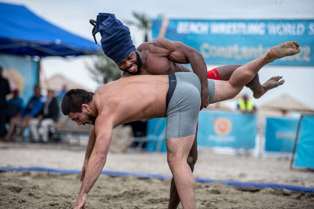 CONSTANTA, ROMANIA - SEPTEMBER 03: (EDITORIAL USE ONLY) In this handout image provided by United World Wrestling, Jabari Montez Irons (top) of the USA competes against Ilia Georgiev Hristov of Bulgaria during the first day of the fifth stop of the UWW Beach Wrestling World Series on September 03, 2022 at Constanta, Romania. (Photo by Dean Treml/UWW via Getty Images)