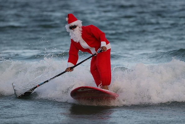 Santa Claus Hits Florida Beach to Catch Some Charitable Waves