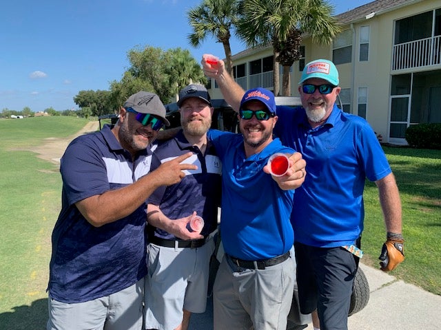 Golfers doing jello shots trying to be the drunkest golfers on the course