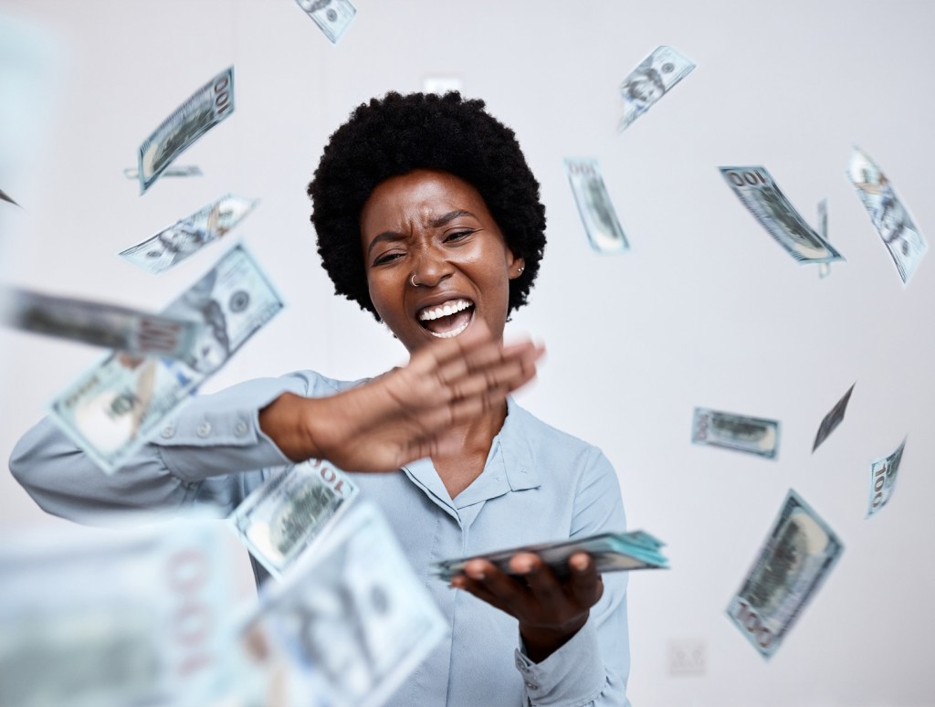 Woman making it rain in the club after learning about the Best Florida Lottery Tickets to buy.