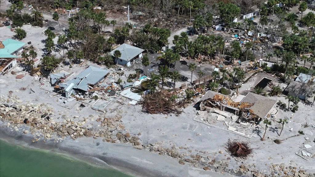 In an aerial view, homes along the Gulf of Mexico are seen after they were destroyed when Hurricane Milton passed through the area on October 12, 2024, in Manasota Key, Florida. People continue recovering following the storm that made landfall as a Category 3 hurricane in the Siesta Key area of Florida, causing damage and flooding throughout Central Florida. 