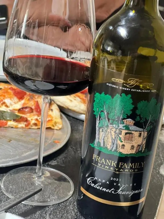 Bottle of Frank Family Cabernet with pizza in the background