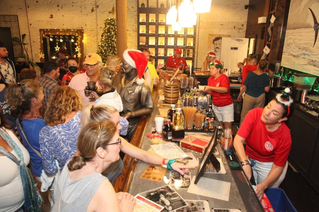 Revelers enjoy the hospitality of Papa’s Pilar Distillery in Key West during last year’s Holiday Historic Inn Tours. This year’s tours are set for Friday evenings, Dec. 8 and 15. (Photo: Carol Tedesco/KeyWestHolidayFest.com)