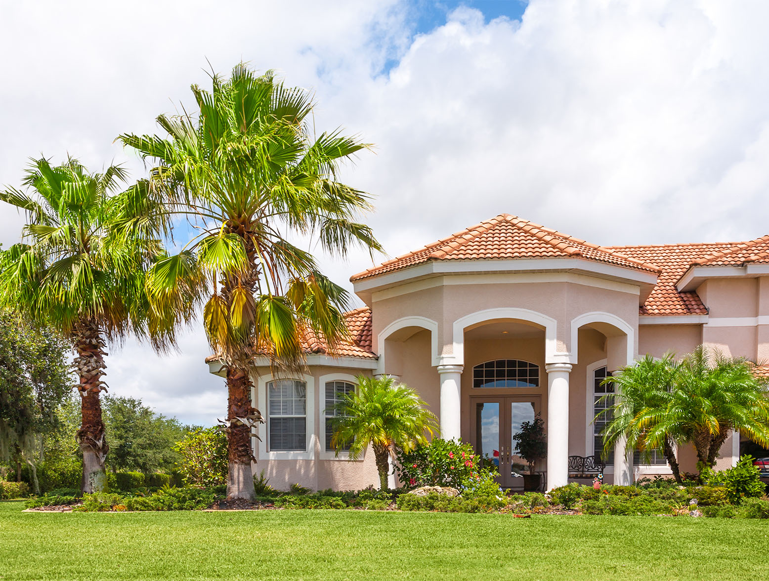 Florida home with palm trees. Ownership becomes difficult with escalating homeowners insurance